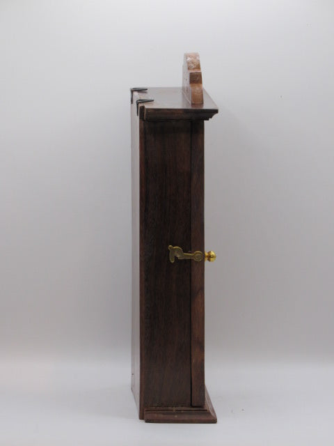 Wooden shelf with metal brackets on a white wall