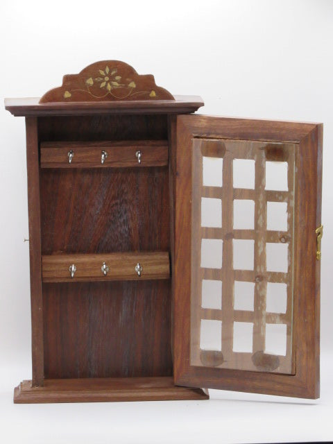 Wooden jewelry box with glass lid on a white background