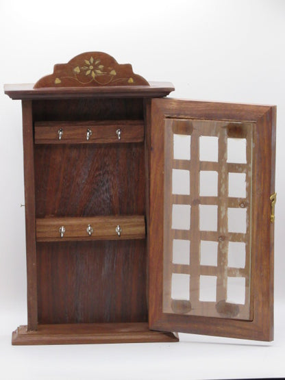 Wooden jewelry box with glass lid on a white background