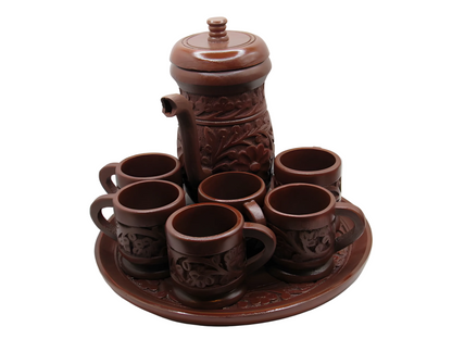 Brown ceramic teapot and cups set on a white background