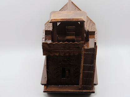 Wooden model of a castle tower on a white background
