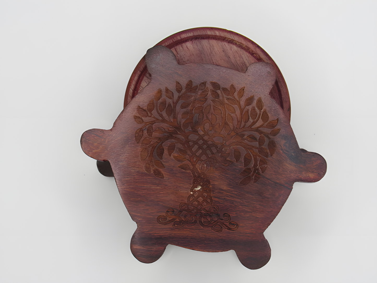 Wooden incense holder with floral design on a white background