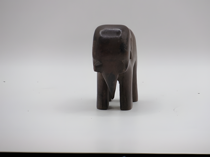 Small dark brown bear figurine on a white background