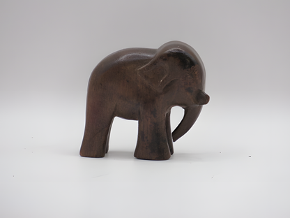 Wooden elephant figurine on a white background