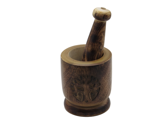 Wooden mortar and pestle with intricate carvings on a white background